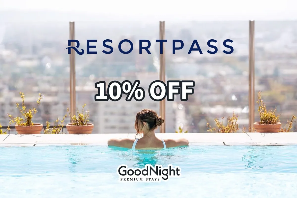 A serene rooftop pool scene at sunset with a woman enjoying a swim. The city skyline is visible in the background, and the tranquil atmosphere is emphasized by soft evening light reflecting off the water.