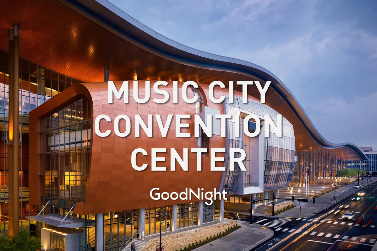 The striking exterior of Music City Center, with its curved roof architecture and modern glass facade. The entrance area is open, inviting, and reflective of a dynamic event and conference venue in Nashville.